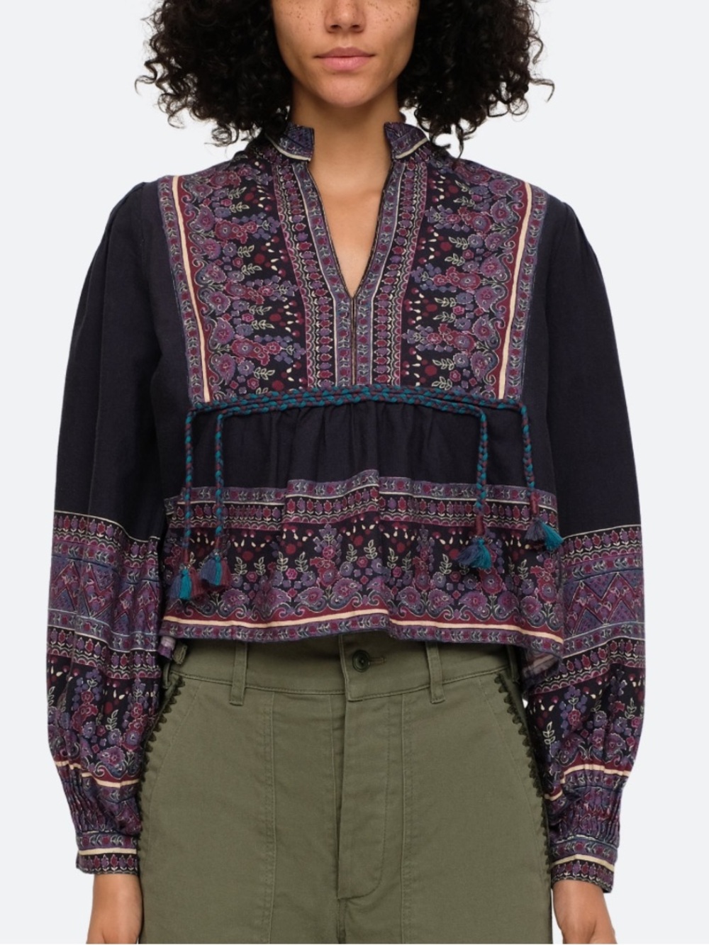 SEA - Adella border print top split v-neckline and braided tassel tie accents.